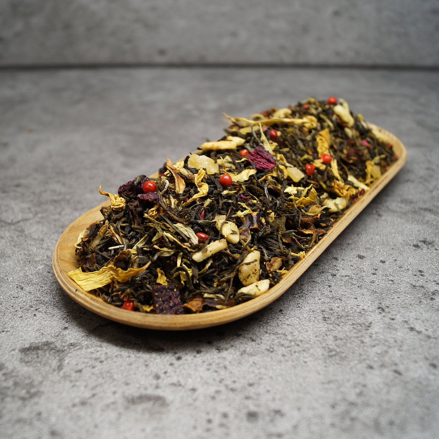 Close-Up of Exotic White Tea Leaves with Pineapple, Mango, and Dragon Fruit