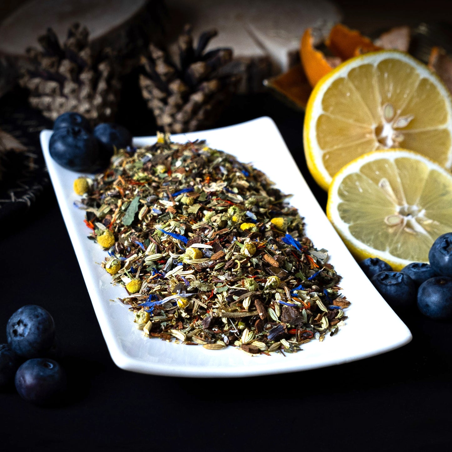 Loose herbal tea blend for Evening Calm — visible rooibos, chamomile petals, fennel, and valerian
