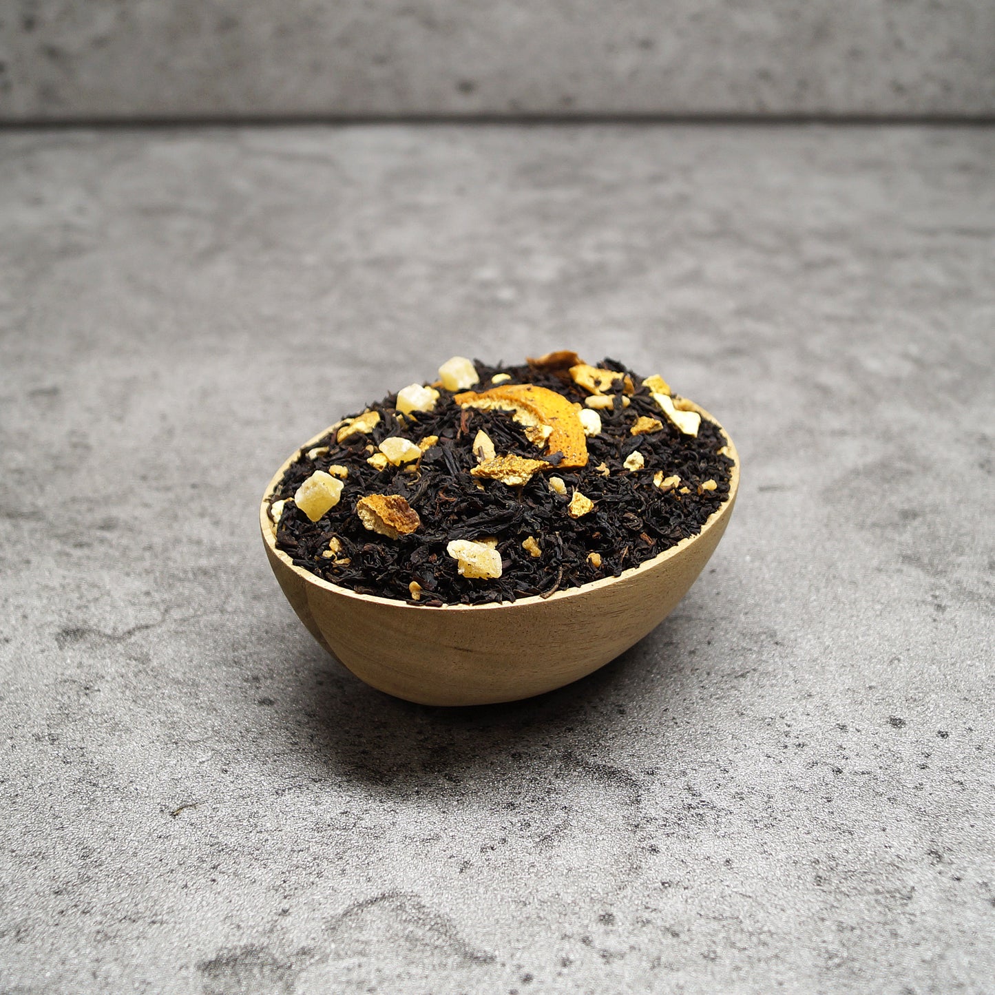 Lapsang souchong black tea leaves in a wooden bowl