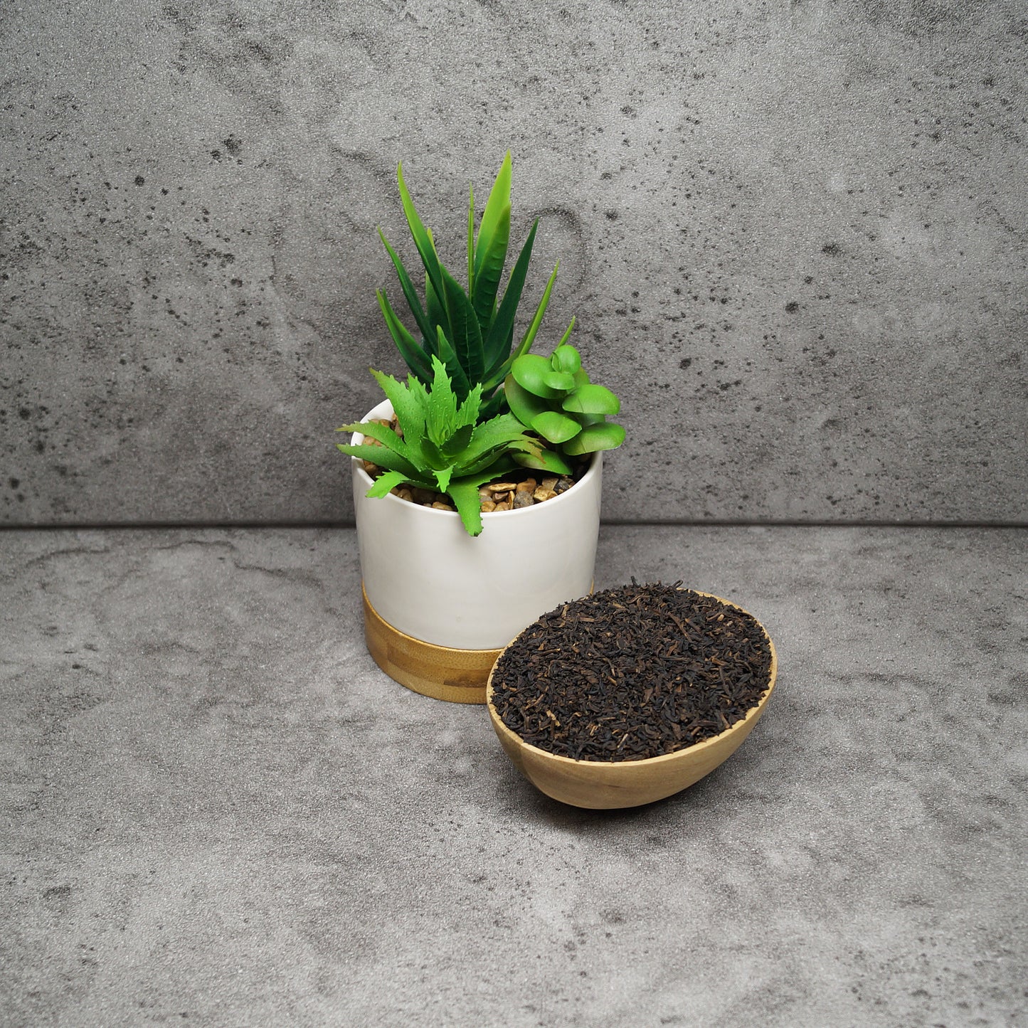 Loose leaf decaffeinated Ceylon black tea leaves spread on a wooden surface