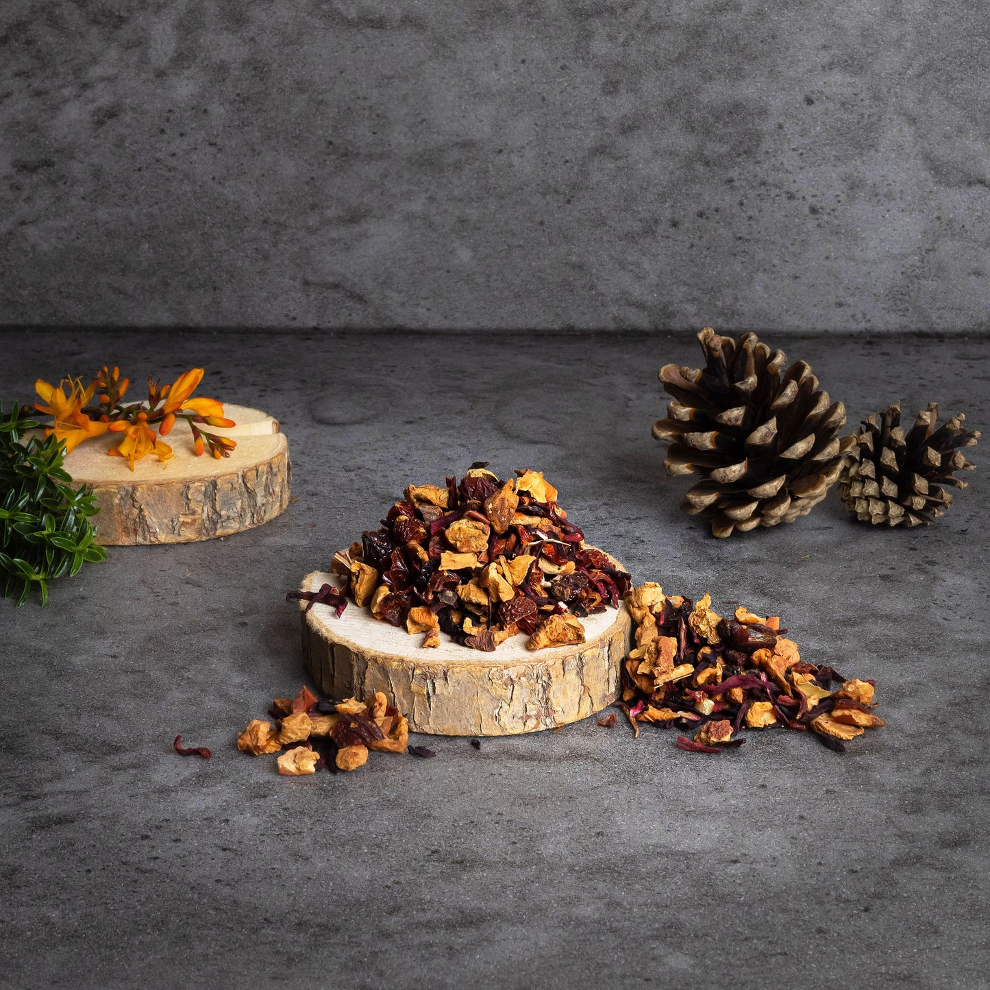 Loose leaf herbal tea blend with visible apple pieces, almond slices, cinnamon bark, and dried hibiscus leaves