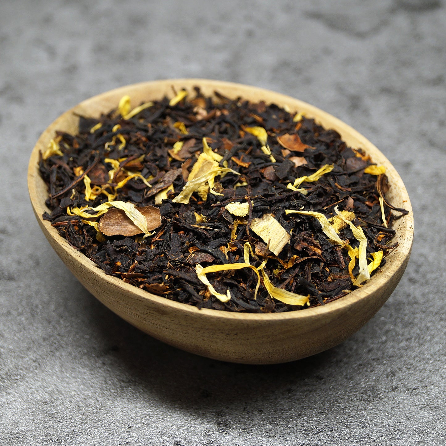 Loose leaf organic rooibos honeybush tea in a wooden bowl