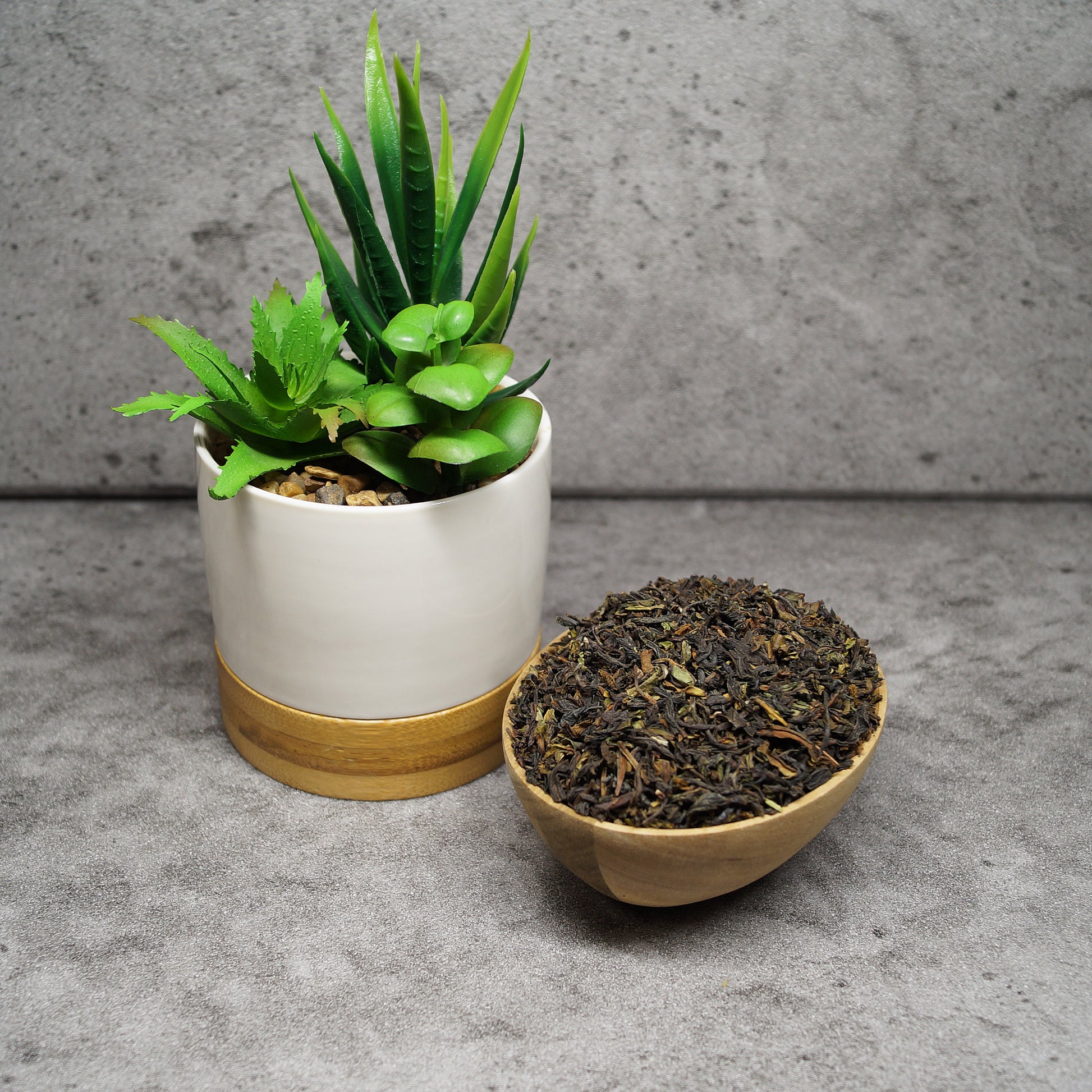 Loose leaf Darjeeling First Flush black tea leaves on wooden surface