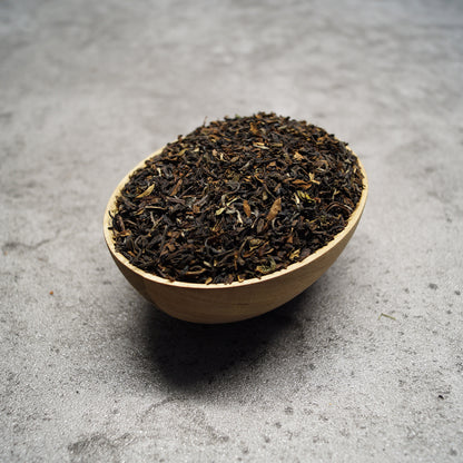 Loose leaf Darjeeling Second Flush black tea leaves on wooden surface