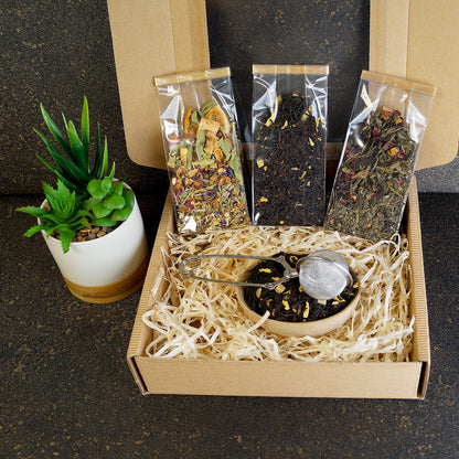 Open view of luxury tea gift set featuring black tea and tea infuser tong